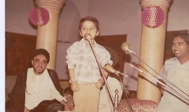 A young student recites before the gathering